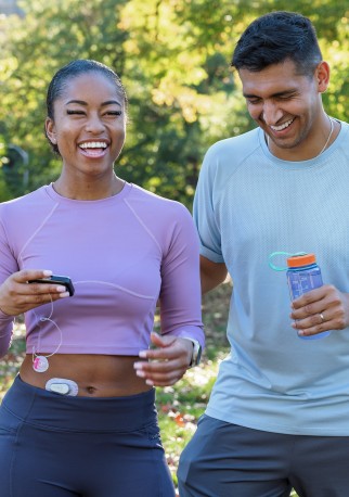 Two people in the park, one with a Dexcom G6 and Tandem t:slim