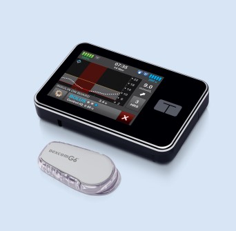 t:slim X2 on a bed with dexcom