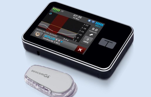 t:slim X2 on a bed with dexcom