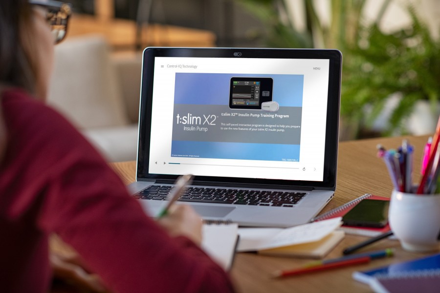 Photograph of the T:Slim X2 Training Module video on a laptop