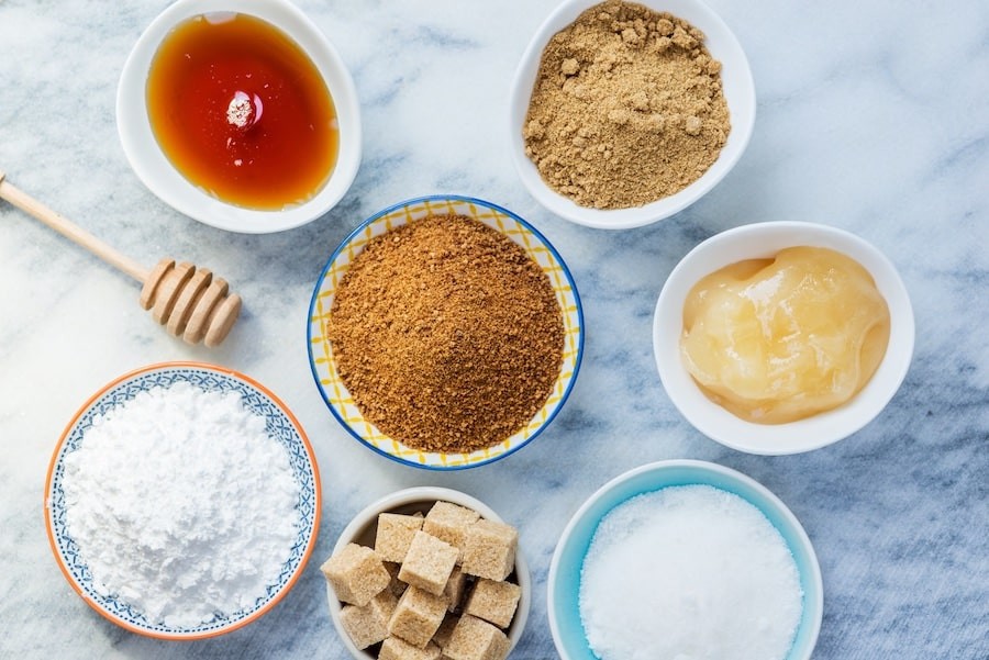 Bowls of different sugars on a countertop