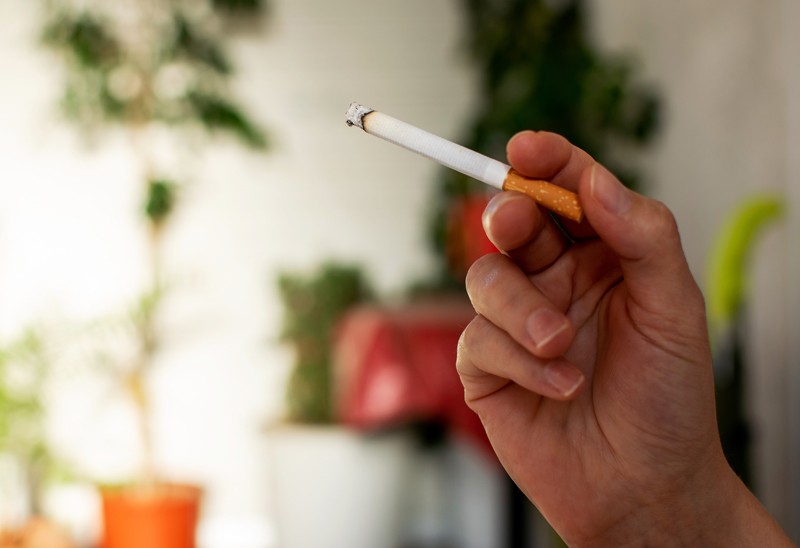 Hand holding a cigarette 