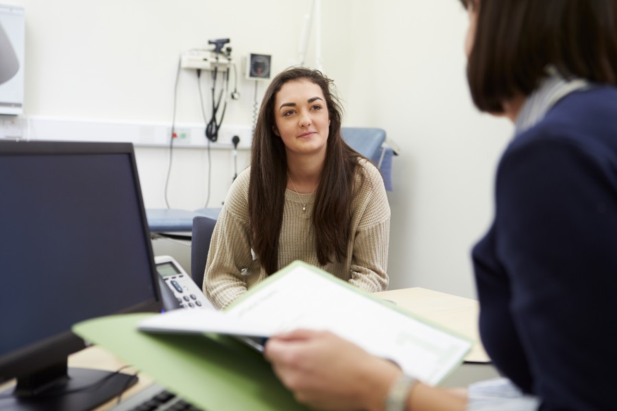 Girl sits in doctors office