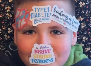 Mylo with fun diabetes based stickers on his face