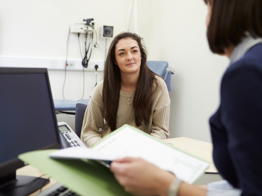 Girl sits in doctors office