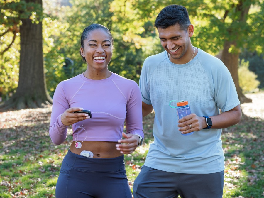 Two people in the park, one with a Dexcom G6 and Tandem t:slim