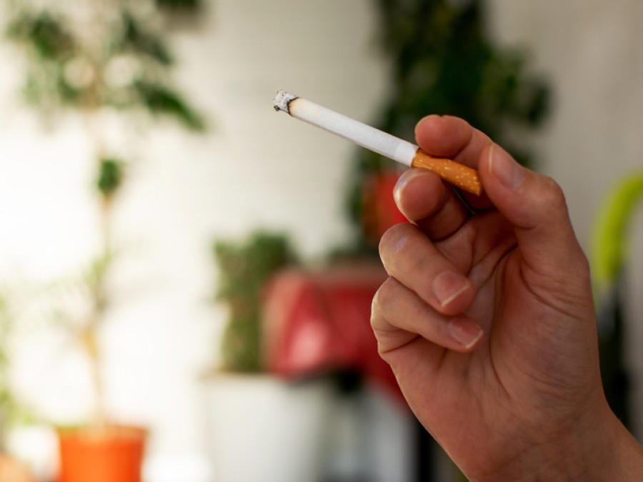 Hand holding a cigarette 