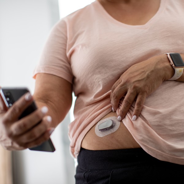 Woman checks her continuous glucose monitor